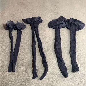 3 black fishnet stockings with lace on top.  Never worn. See pics for size